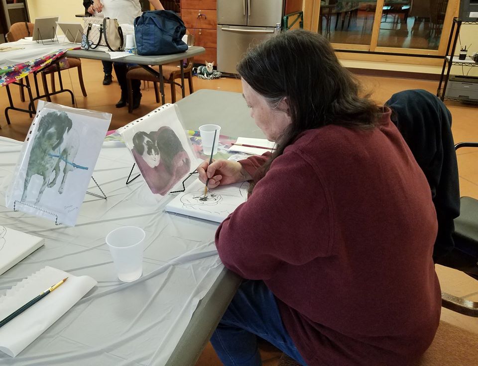 Person painting at a table